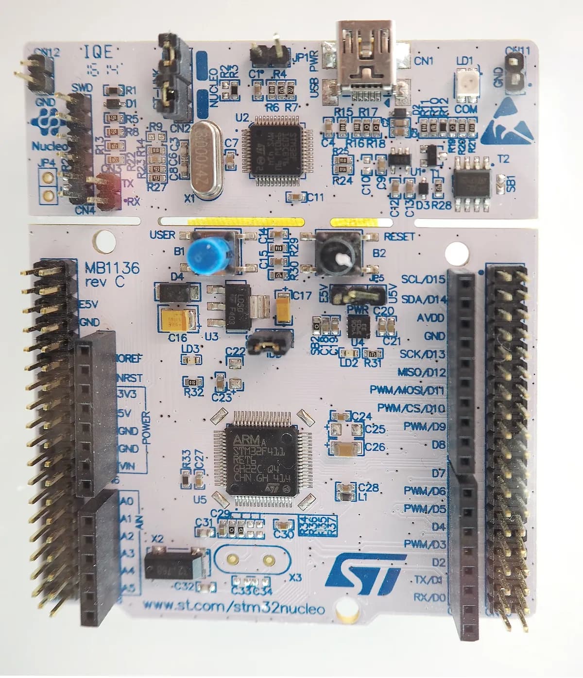An STM32 Nucleo development board with its pin headers and ST-LINK debugger section